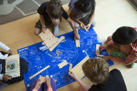 Group of kids assembling the Piper kit