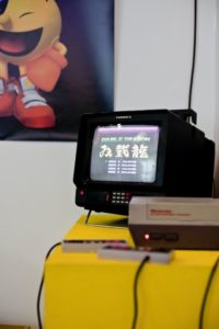 Double Dragon on a CRT screen, NES console, and Pac-Man poster featured