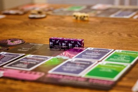 An array of cards and dice used for playing games on a table