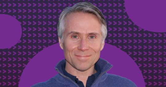 Mark Deloura, Executive Director of Innovation & Growth headshot on a patterned purple background.1